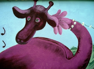 Dragon painted in mural over newly rendered wall