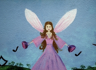 Fairy painted in mural on Kindergarten rendered wall